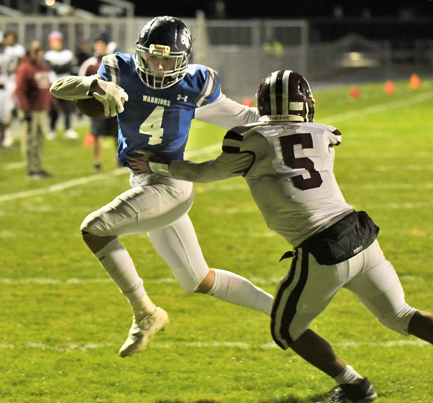 Whitesboro's Tony Dorozynski makes a move on Auburn tackler Elijah Scott to score the team's third touchdown of the first quarter Friday night at home in the Section III Class A quarterfinals. The Warriors won 42-7 to advance.