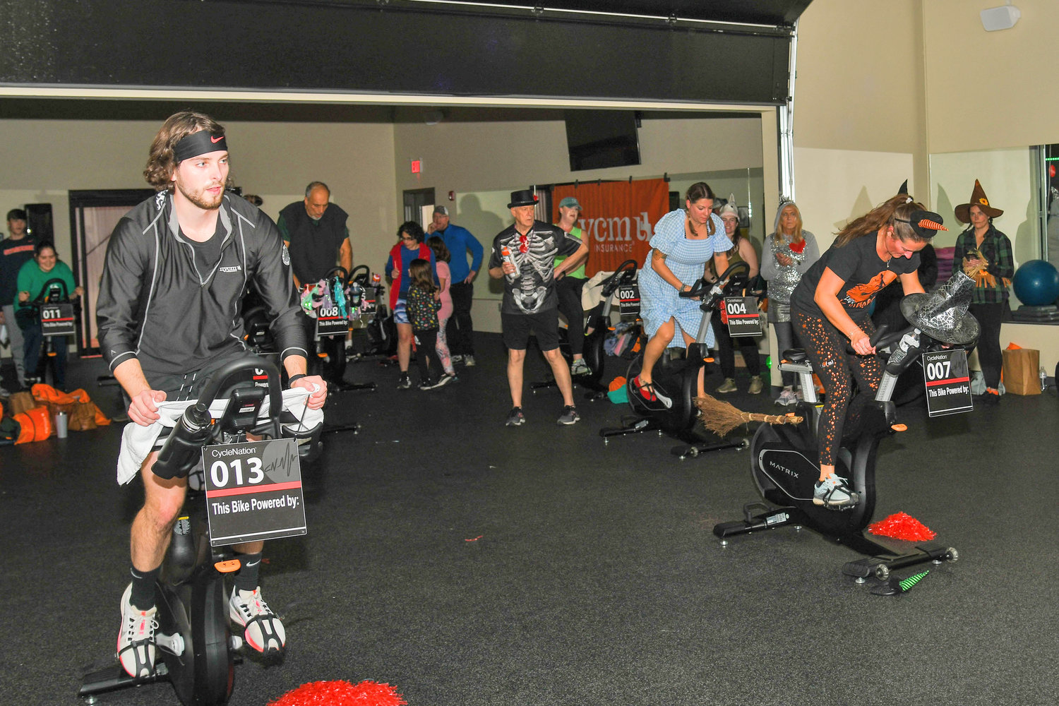 Guests participate in CycleNation, a relay-style, stationary cycling event that fights stroke on Thursday, Oct. 27 at Carbone Athletics at the Fitness Mill. Blood pressure screenings and health information were also available for participants.