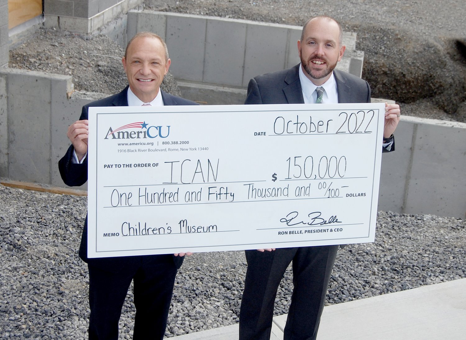 Ron Belle, AmeriCU president and CEO, left, presents a check for $150,000 to Steven Bulger, ICAN executive director and CEO, recently. The funds will be used to help construct the gift shop in the Children’s Museum at ICAN’s Family Resource Center in Utica.