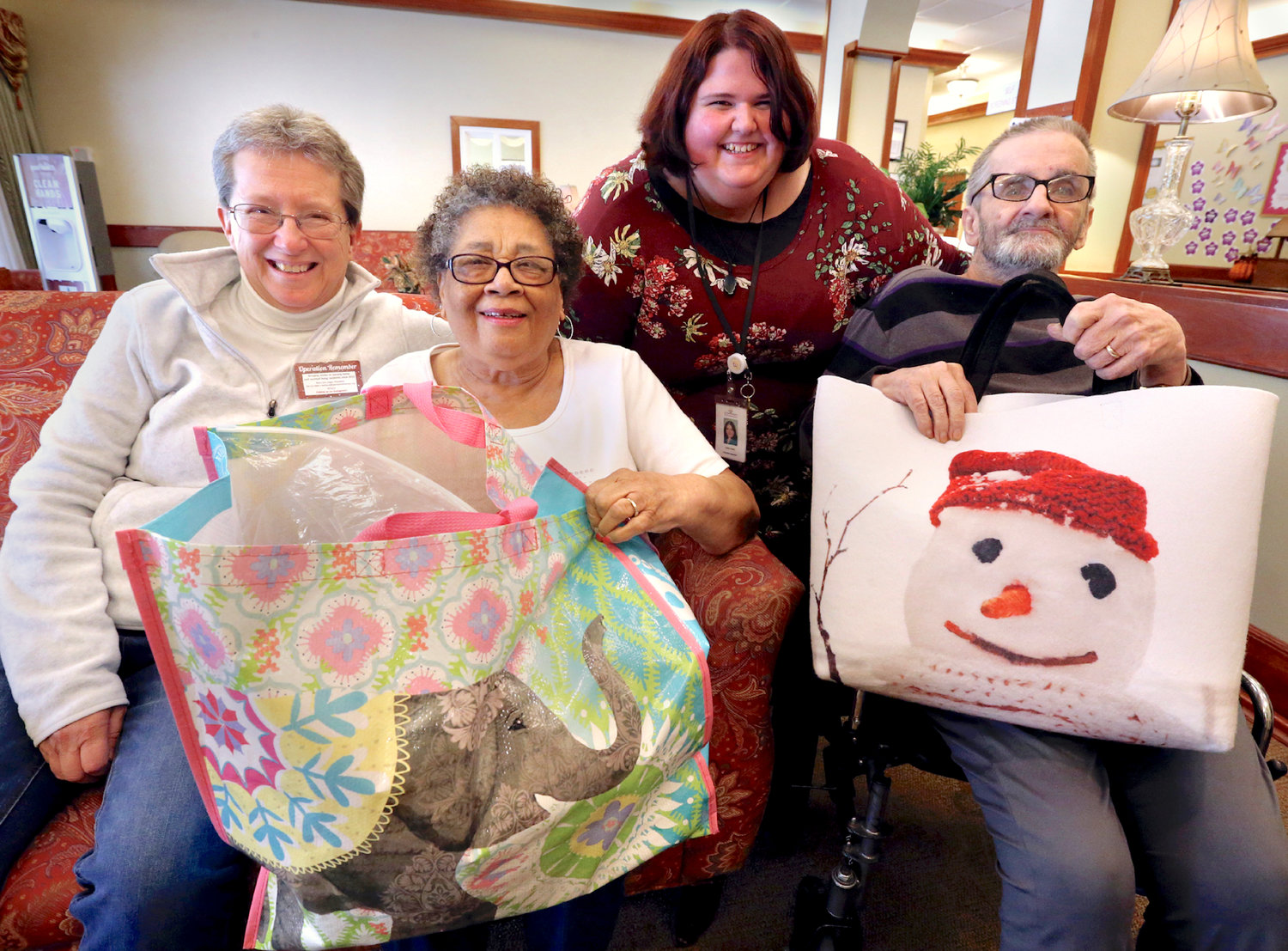 Betty Sue Unger, left, started Operation Remember 10 years ago at Evergreen Health &amp; Rehab Center in Winchester, Va., to bring a little holiday cheer to the facility’s residents, pictured on Oct. 19, are resident Helen Walker, from left, Activities Assistant Caitlin Peele and resident Buzzy Braithwaite. “It was supposed to be a one-time thing,” she said. Since then, the group has grown into a full-fledged nonprofit that delivers Christmas presents and other gifts year-round to seven area nursing homes.