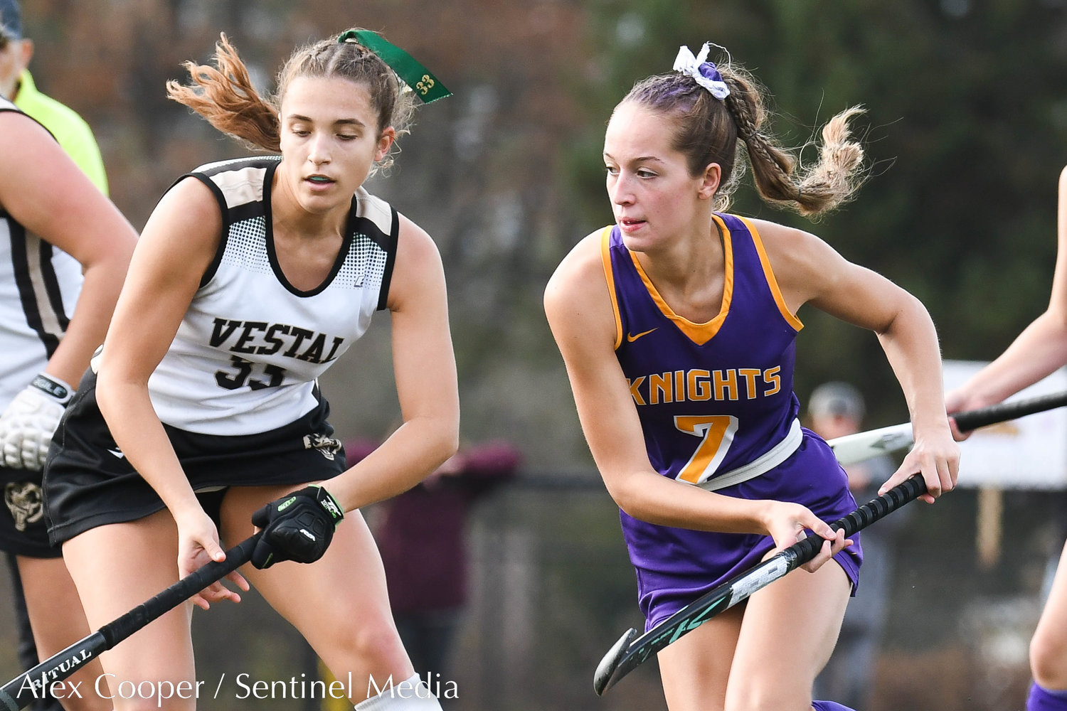 Holland Patent player Alivia Alexander (7) fights for control of the ball during the Class B field hockey state regional against Vestal on Saturday at Sidney High School.