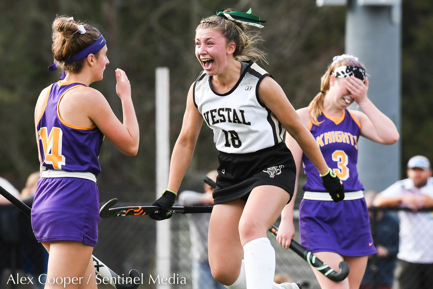 Holland Patent players Zoe Kelly (14) and teammate Michaela Cushman (3) react as Vestal player Adrienne Mayes, center, celebrates after beating the Golden Knights 2-1 in the Class B field hockey state regional on Saturday at Sidney High School.