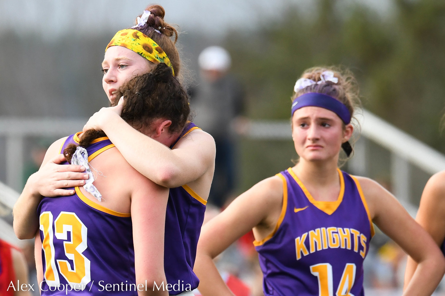 From left, Holland Patent player Abby Draper comforts teammate Izzy Stalker (13) after losing the Class B field hockey state regional to Vestal 2-1 on Saturday at Sidney High School.