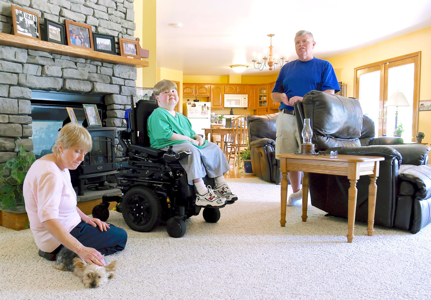 Terry Horgan with his parents in the family’s Montour Falls, N.Y., home. Horgan, a 27-year-old who had Duchenne muscular dystrophy, died last month.