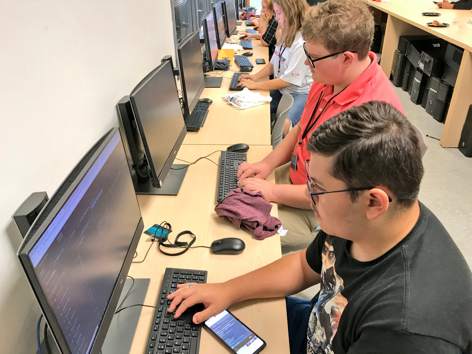 High school students, including Tylor Graf, front, and Michael Cannistra came out Saturday for the first time to join regional college students for the CNY Hackathon at Mohawk Valley Community College in Utica.