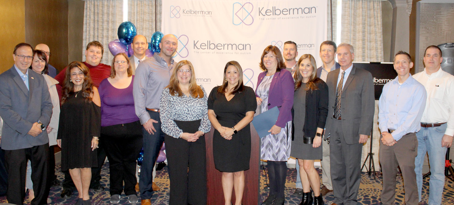 Local dignitaries, community members and Kelberman officials gather recently to celebrate the rebranding of the local provider of autism services and programs.