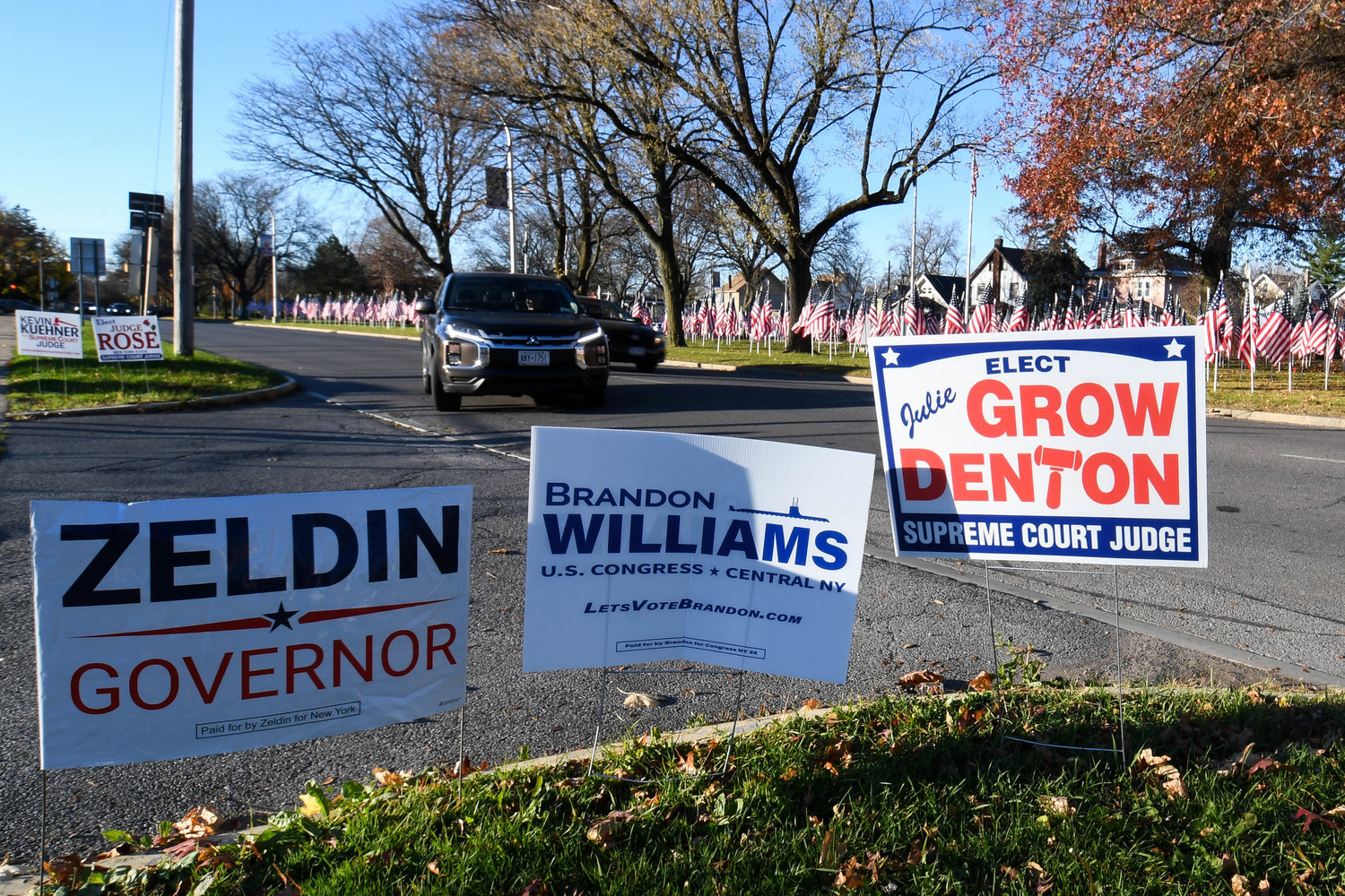 Candidate lawn signs decorate the entrance to the Parkway Center on Tuesday, Nov. 8 in Utica. Oneida County election commissioners reported a busy day at the polls, with some 4,500 to 4,700 voters each hour going to cast their ballots across the county.