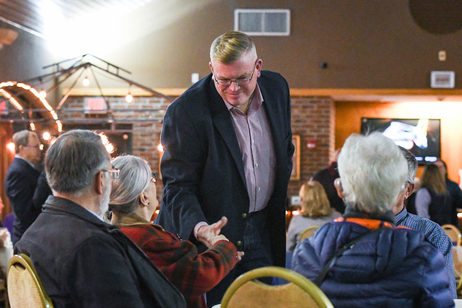 Oneida County Sheriff Robert Maciol shakes hands with supporters during an election party hosted on Tuesday night at Aqua Vino Restaurant in Utica.