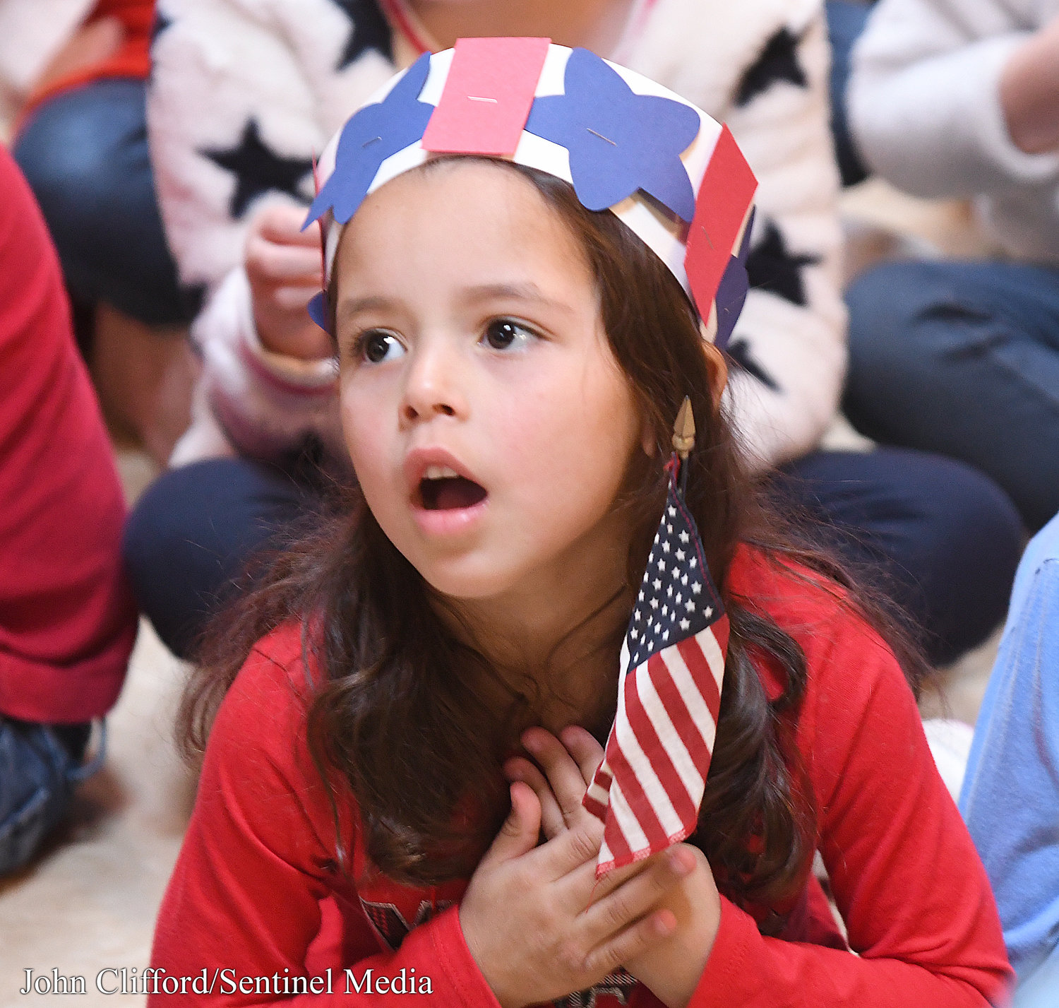 Kindergartener Sofia Lozada sings patriotic songs during the Stokes Elementary School Veterans Day ceremony Thursday, November 10, 2022.