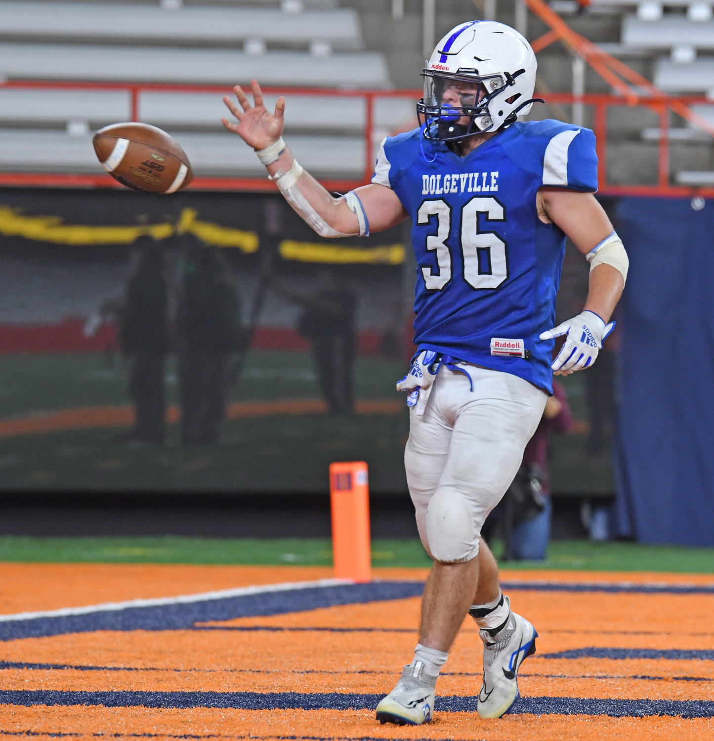 Dolgeville's Jared Bilinski tosses the ball to a referee after scoring a touchdown on Friday afternoon during the Class D final at the JMA Wireless Dome in Syracuse. Bilinski totaled four rushing touchdowns in the Blue Devils' 44-24 victory over Beaver River