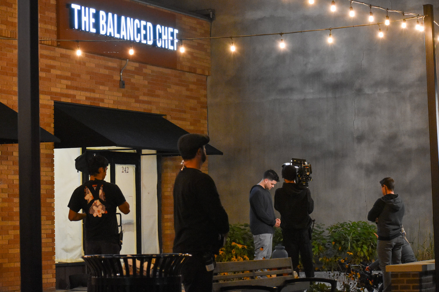 Production crew stand outside The Balanced Chef at 242 West Dominick Street in Rome on Thursday evening. The restaurant will be on the Food Network T.V. show, “Restaurant: Impossible.” Photo taken November 10, 2022.