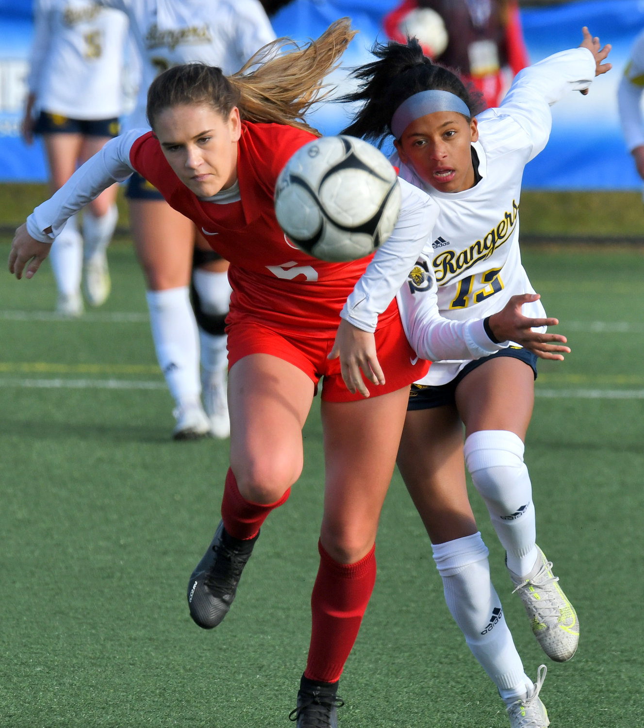 New Hartford's Alex Volo and Spencerport'sd Ileana Cheruiyot fight to get to the ball Saturday afternoon at Tompkins Cortland Community College. New Hartford advanced to the state Class A final on Sunday morning. New Hartford is the defending champions.