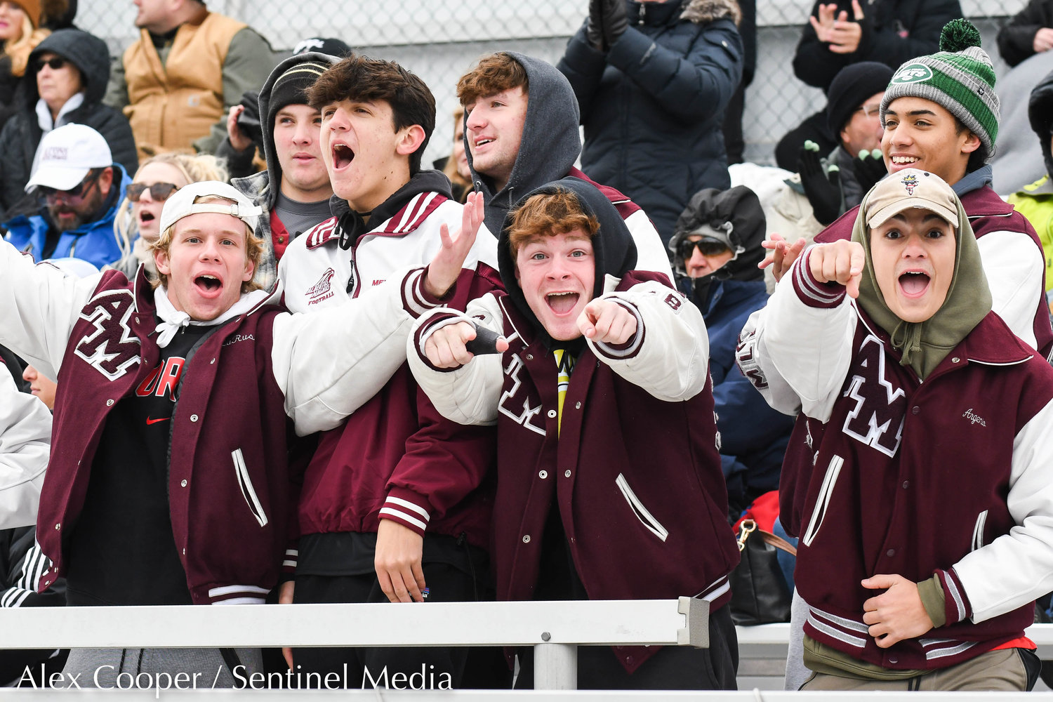 Albertus Magnus students cheer from the bleachers during the Class A state final against New Hartford on Sunday at Tompkins-Cortland Community College. The Spartans lost 3-1.