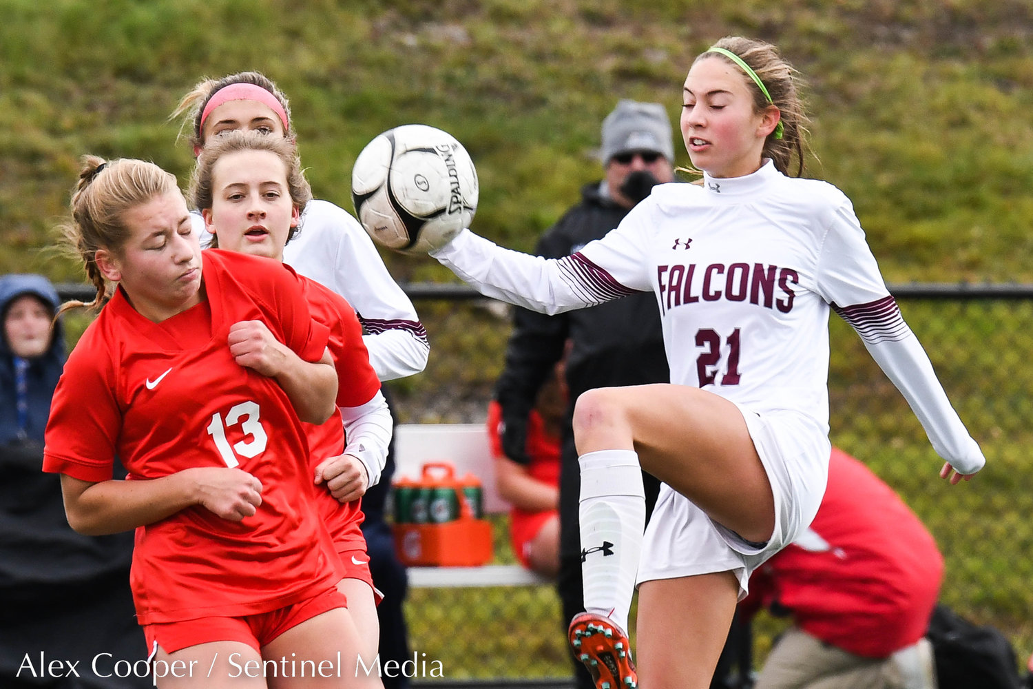 New Hartford player Willa Pratt (13) avoids getting hit as Albertus Magnus player Courtney Mclachlan (21) kicks the ball during the Class A state final on Sunday at Tompkins-Cortland Community College. The Spartans lost 3-1.