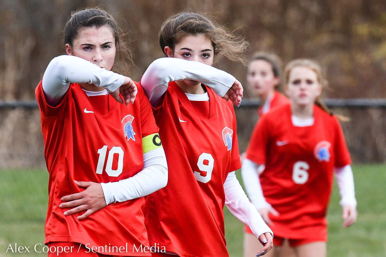 New Hartford players Talia Vitullo (10) and Amanda Graziano (9) protect their face during a corner kick at the Class A state final on Sunday at Tompkins-Cortland Community College. The Spartans lost 3-1.