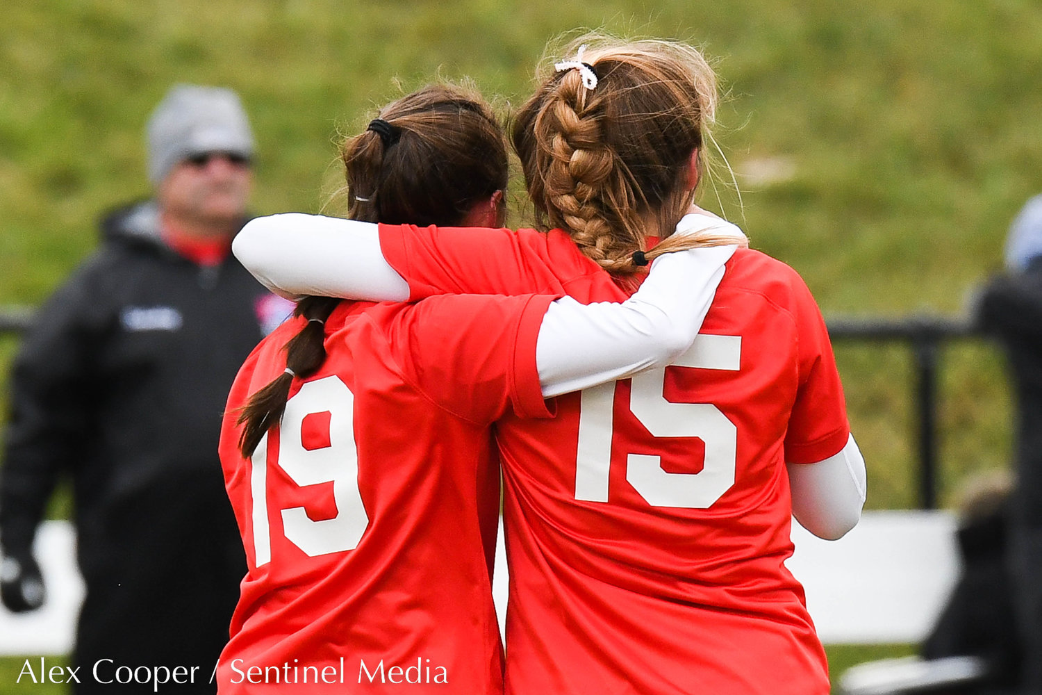 New Hartford players Biddie Clive and Anna Rayhill hug after losing to Albertus Magnus 3-1 in the Class A state final on Sunday at Tompkins-Cortland Community College.