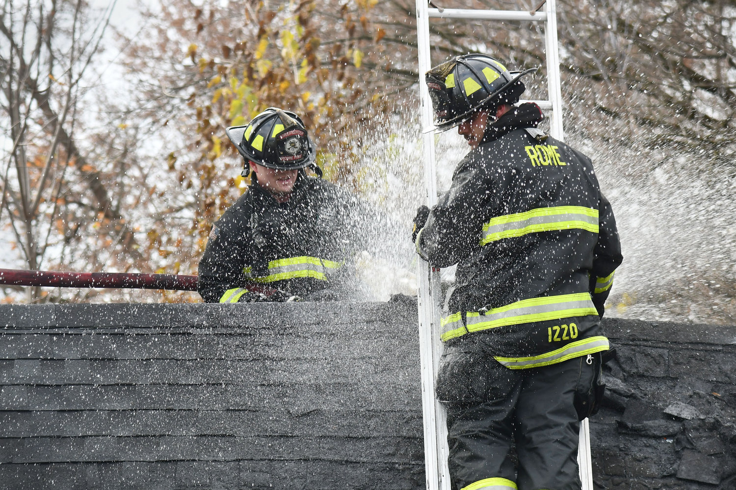 Rome firefighters spray the smoldering roof of a garage that caught fire Monday at 310 S. George St. Fire Chief Thomas Iacovissi said smoke and flames were visible upon arrival, but the fire was knocked down quickly. The cause remains under investigation. No injuries were reported.