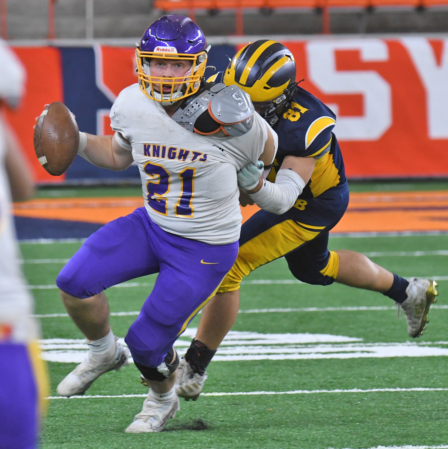 Holland Patent quarterback Jonathan Zylynski looks to throw the ball but is wrapped up by General Brown’s Devin Hicks in the second quarter at JMA Wireless Dome Sunday in the Section III Class C championship game. General Brown won 41-0.