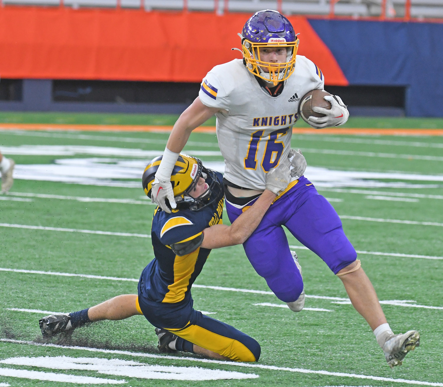 General Brown’s Ben Eichhorn hangs on to Holland Patent tight end Nicholas Deforrest in the first quarter Sunday afternoon at JMA Wireless Dome in Syracuse. General Brown won the Section III Class C title game 41-0.