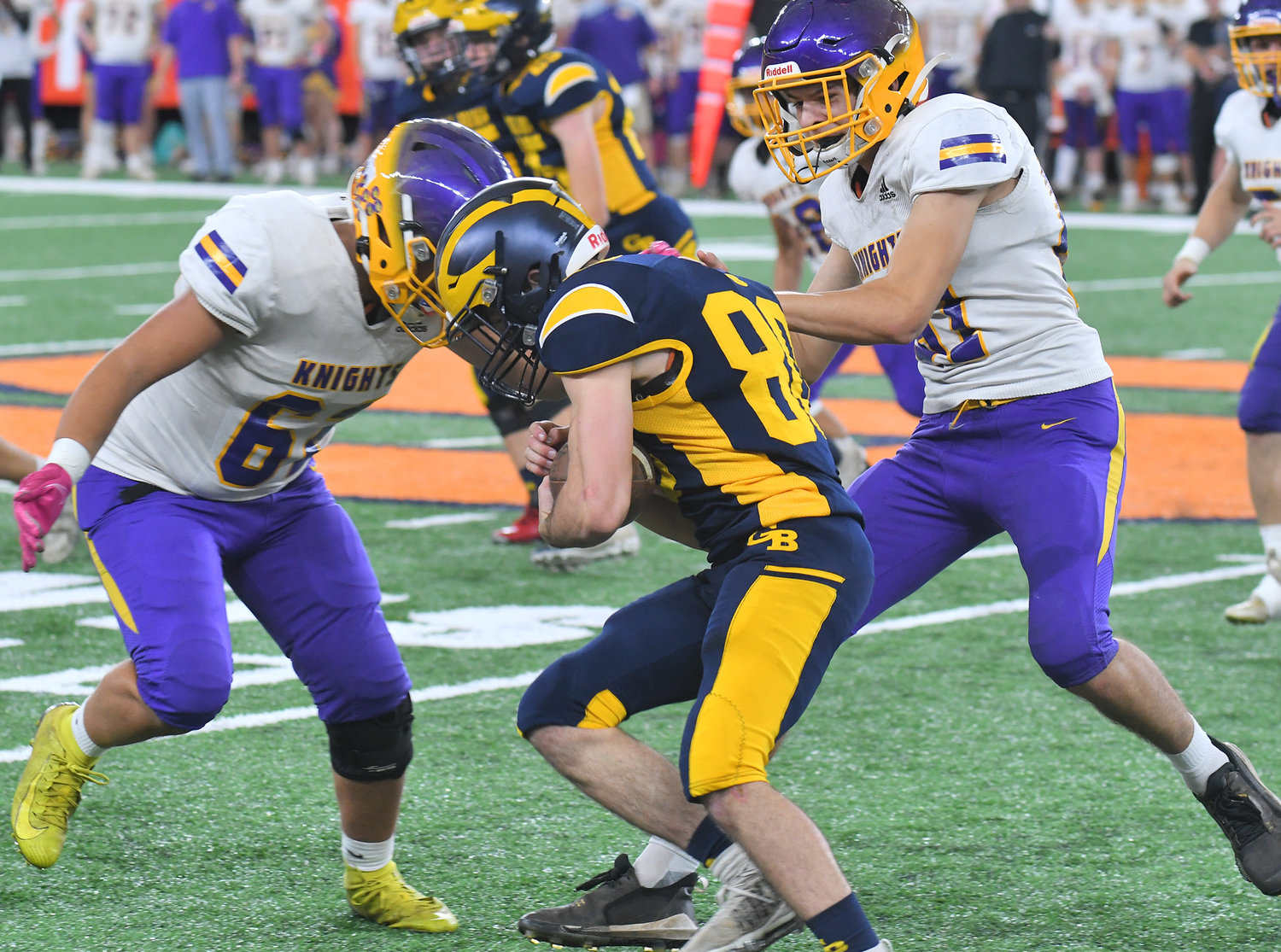 Holland Patent defensive linemen Brent Mott, left, and Devyn Priz team up to tackle General Brown’s John Chamberlain in the second quartter at JMA Wireless Dome in Syracuse Sunday in the Section III Class C title game. General Brown won 41-0.