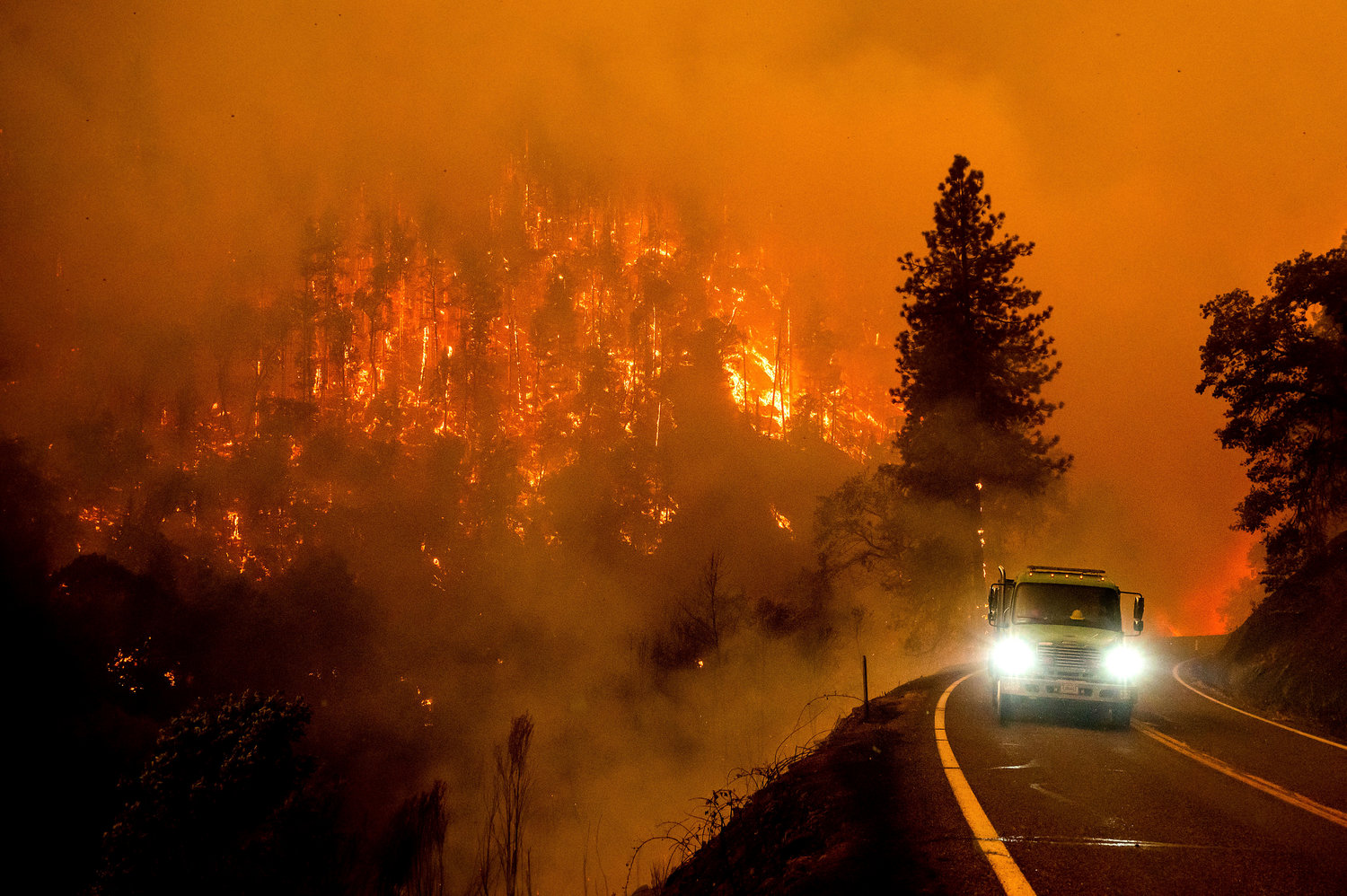 FILE - A firetruck drives along California Highway 96 as the McKinney Fire burns in Klamath National Forest, Calif., on July 30, 2022. 90% of counties in the United States experienced a weather-related disaster between 2011-2021, according to a report published on Wednesday, Nov. 16, 2022. Over 300 million people ‚Äî 93% of the country‚Äôs population ‚Äî live in those counties. (AP Photo/Noah Berger, File)