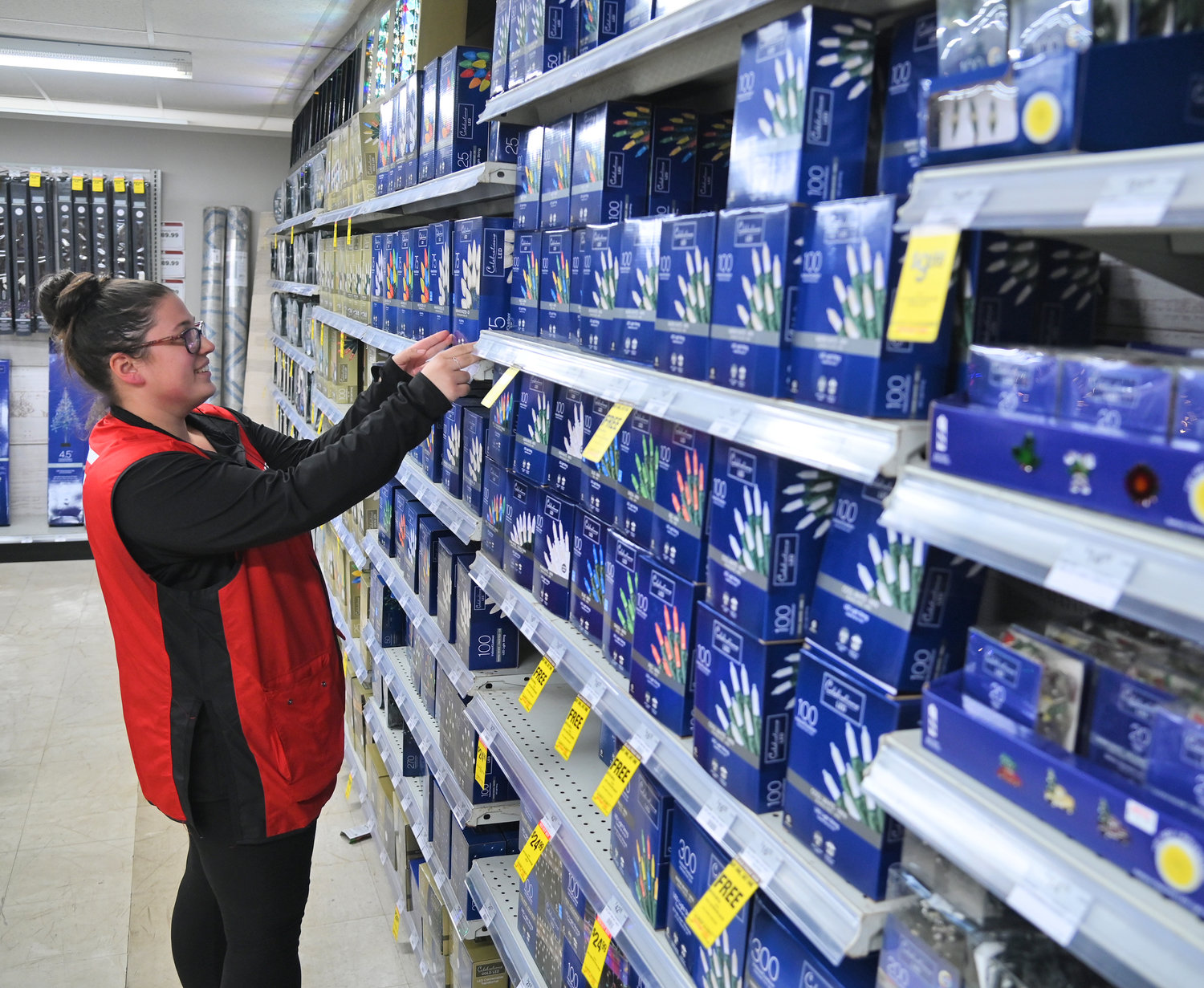 Alex Bauer, a supervisor at ACE Hardware, 115 Black River Blvd. South, checks shelves and shelves of Christmas lights on display at the store Friday, Nov. 18. The store, which has an array of gifts for both the handy, and the not-so-handy, is among the places where folks can Shop Rome First.