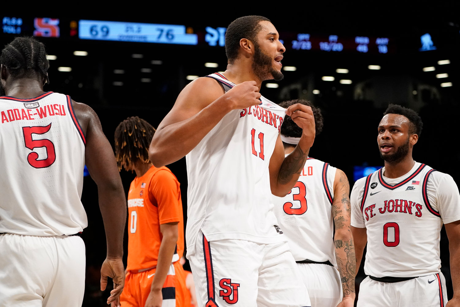 St. John's Joel Soriano (11) reacts toward Syracuse fans as his team takes the lead in overtime of the championship game at the Good Samaritan Empire Classic on Tuesday night in New York. St. John's won 76-69 in overtime.