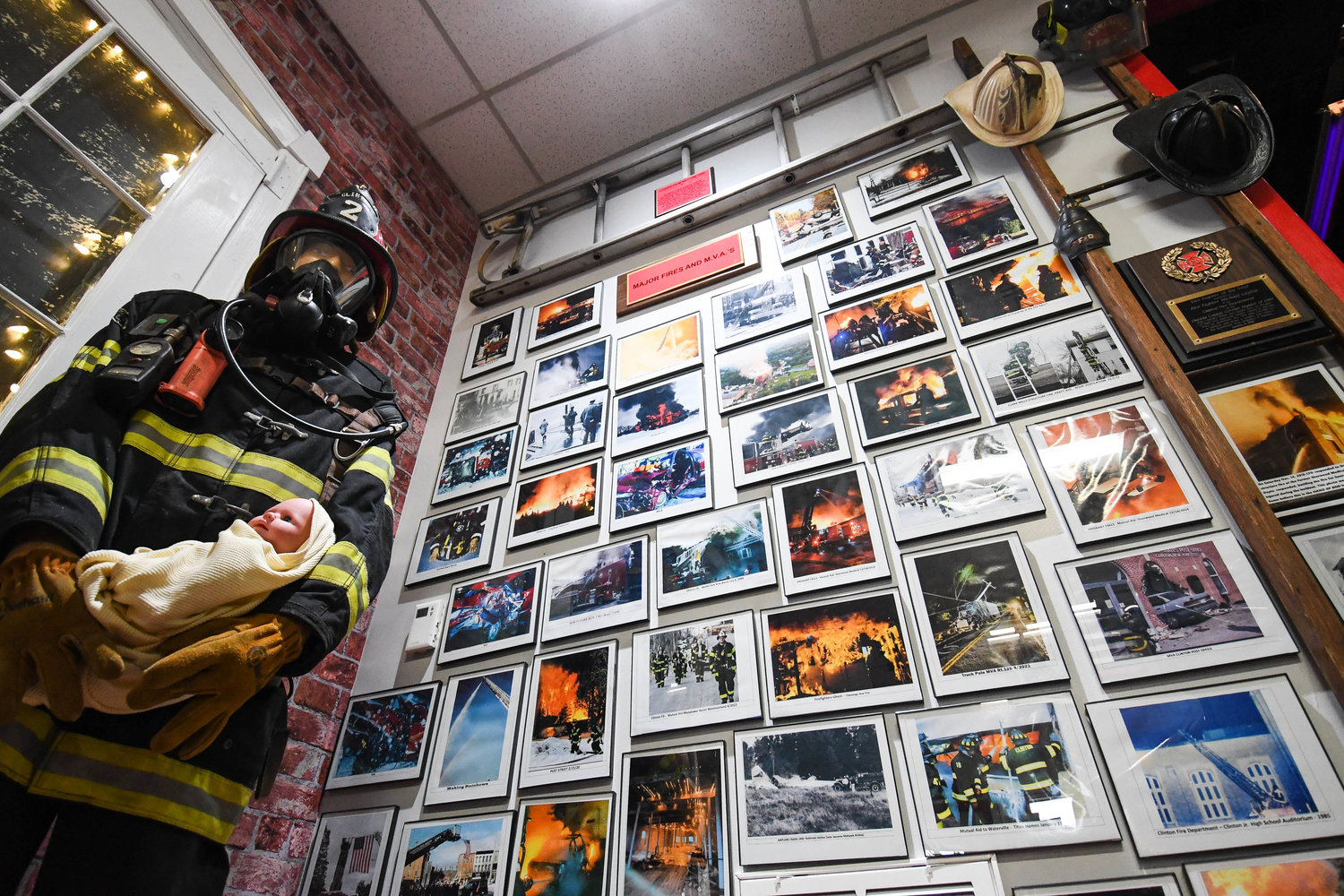 A wall of old photographs showcasing historic fires in the Village of Clinton.