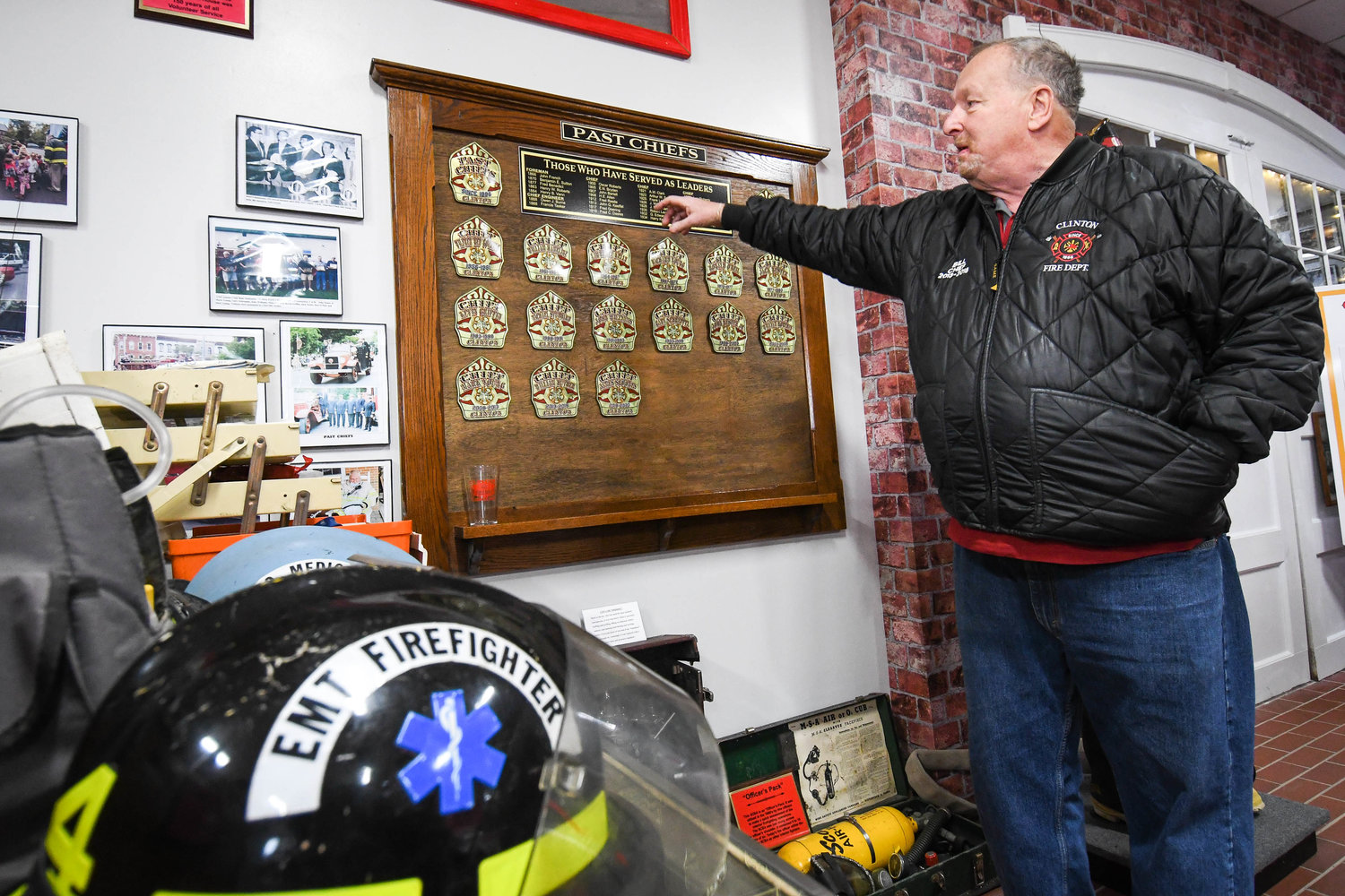 Former fire chief Bill Huther shows a board of past chiefs in the Clinton Fire Department Museum on Franklin Avenue in Clinton. The line of chiefs dates back more than 150 years.
