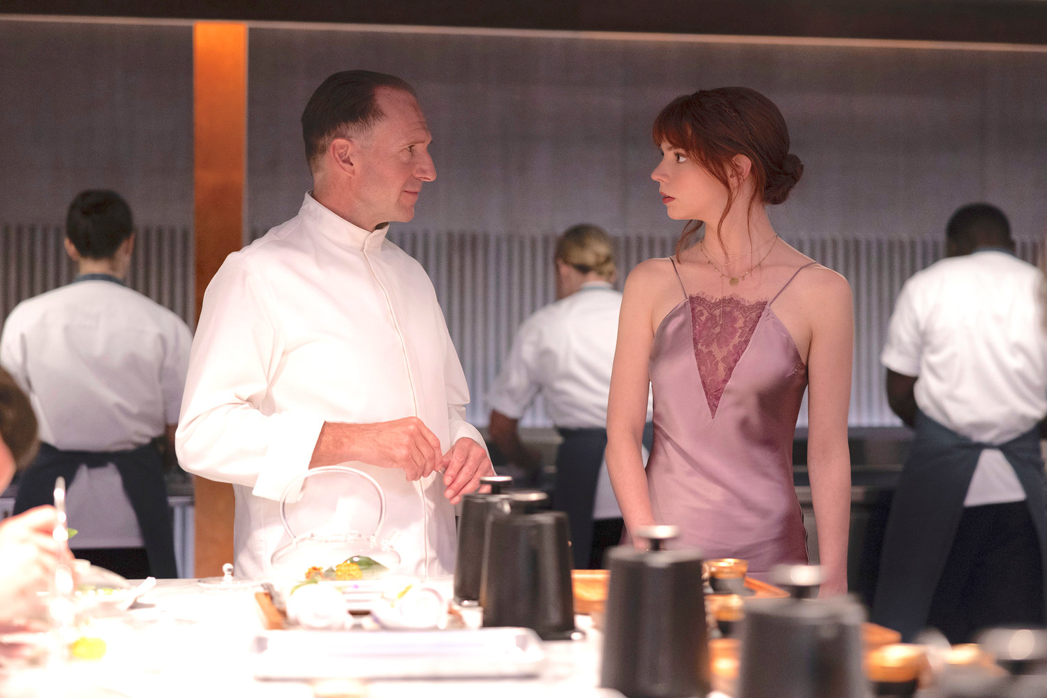 Ralph Fiennes, left, and Anya Taylor-Joy in a scene from the film ‘The Menu.’