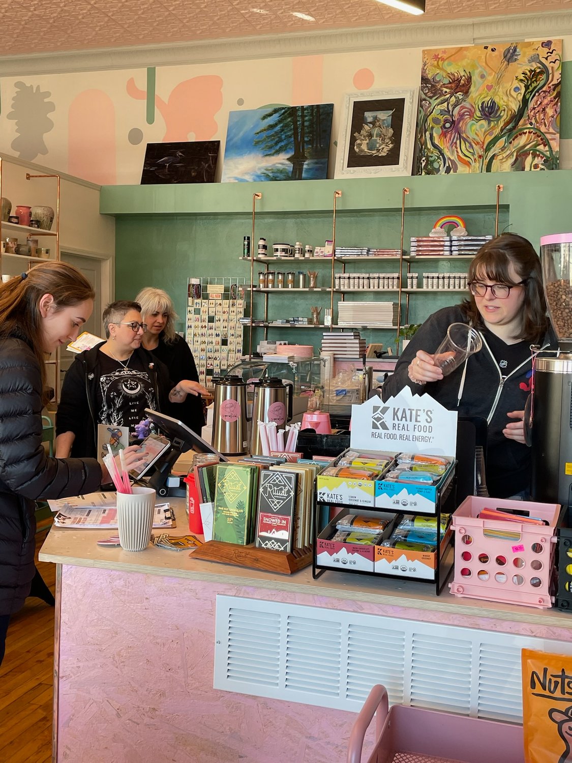 Caitlin Matwijec-Walda, right, co-owner of superofficial coffee shop at 216 W. Dominick St., whips up a speciality drink for a customer during Small Business Saturday.