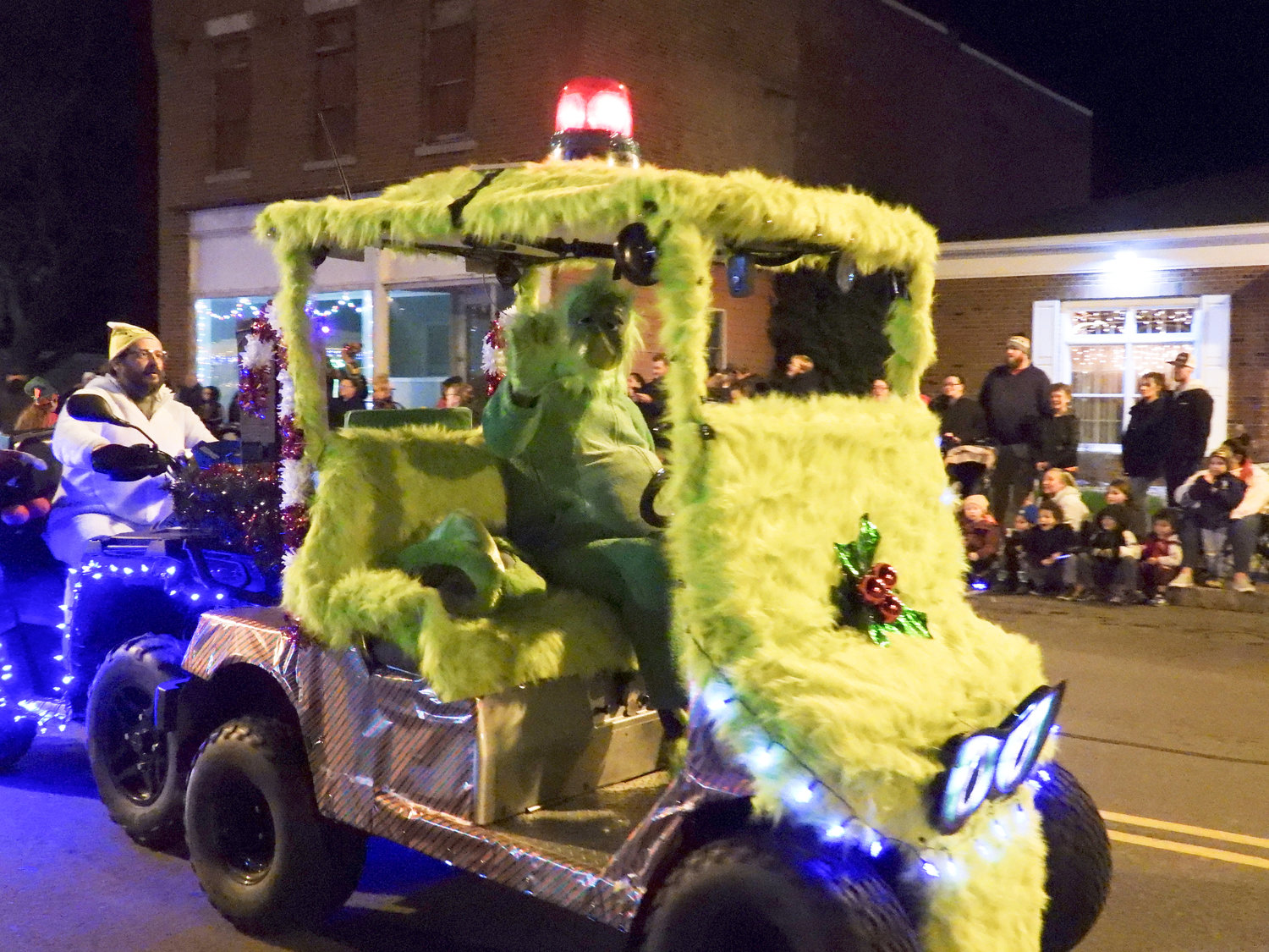 The Canastota Parade of Lights saw people fill the streets Saturday night to welcome in the holiday season. The Grinch waves to people in attendance.