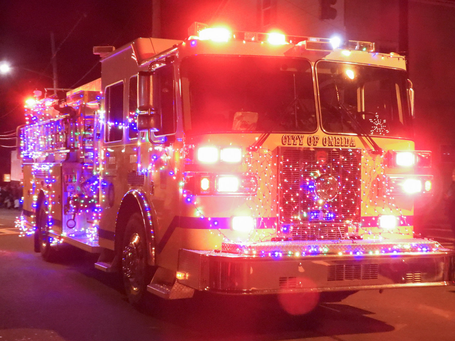 The Canastota Parade of Lights saw people fill the streets Saturday night to welcome in the holiday season. Pictured is a fire truck from the Oneida Fire Department, decked out in lights.