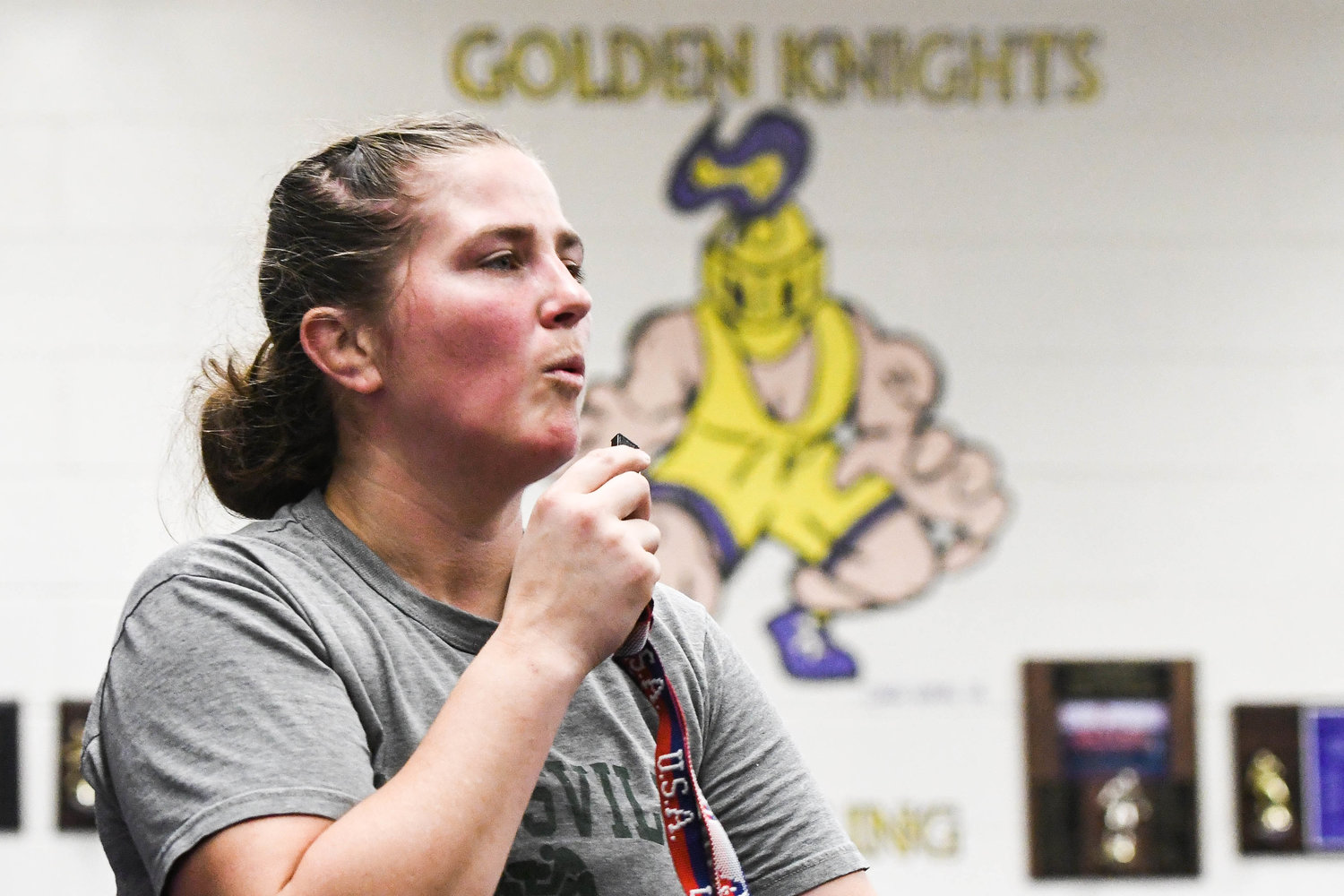 Holland Patent head coach Samantha Doxstader blows a whistle during warm up drills at wrestling practice on Monday at Holland Patent High School.