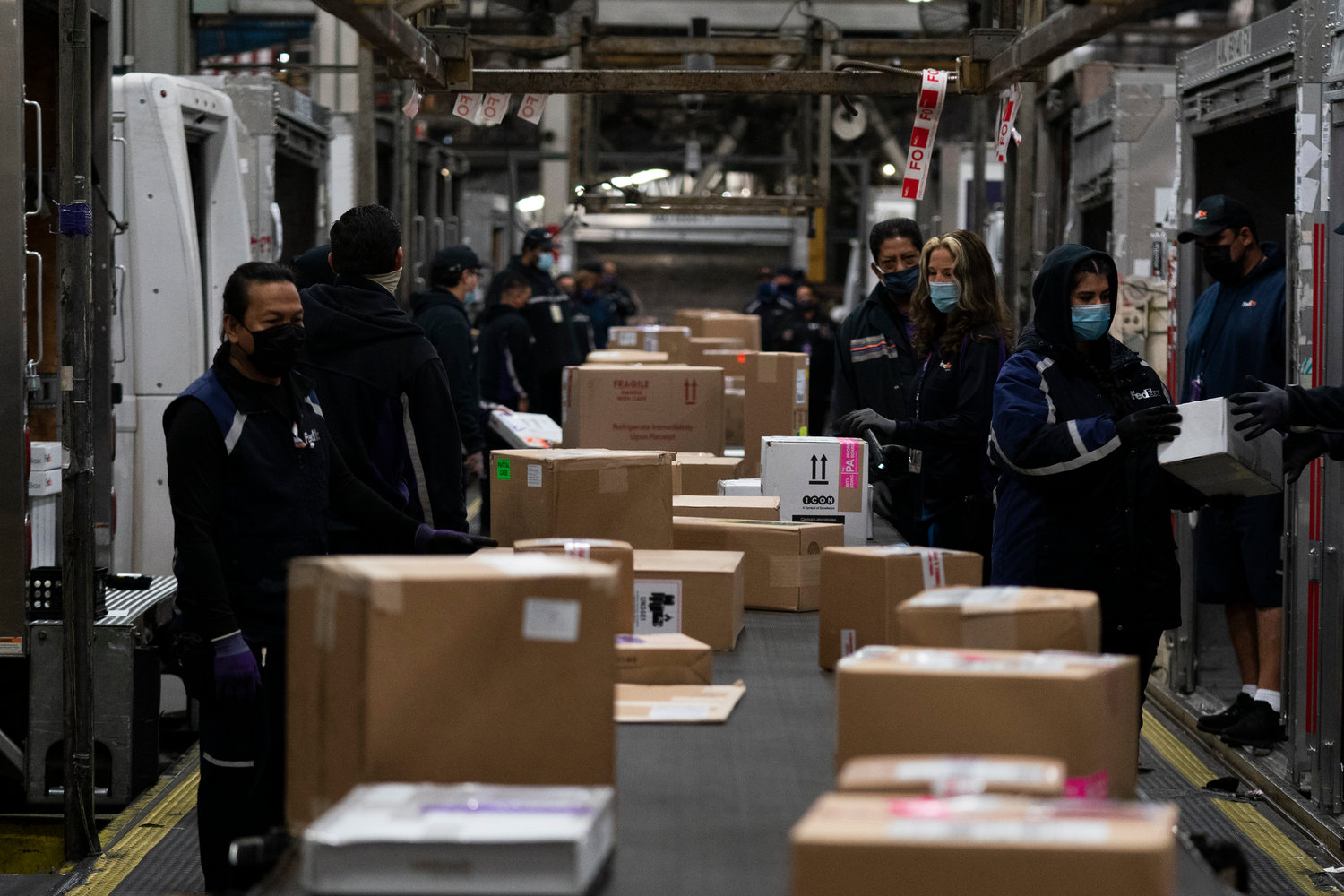 Employees sort packages for delivery at the FedEx regional hub at the Los Angeles International Airport in Los Angeles in this 2021 file photo.