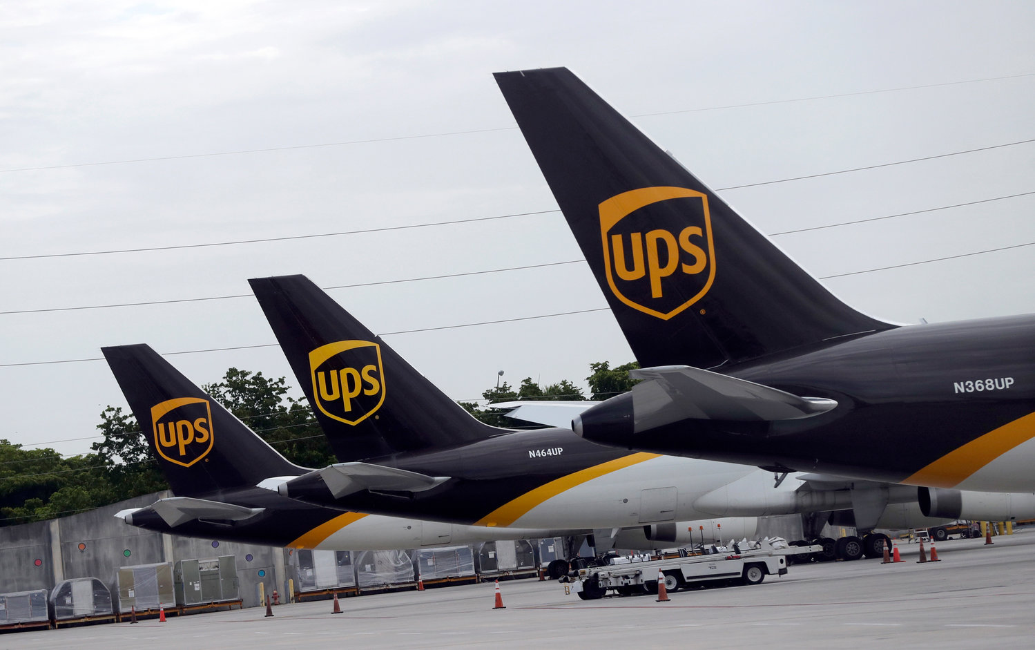 FILE - In this July 27, 2020 file photo, the tails of three UPS aircraft are shown parked at Miami International Airport in Miami. The nation‚Äôs major shipping companies are in the best shape to get holiday shoppers‚Äô packages delivered on time since the start of the pandemic, suggesting a return to normalcy. (AP Photo/Wilfredo Lee, File)