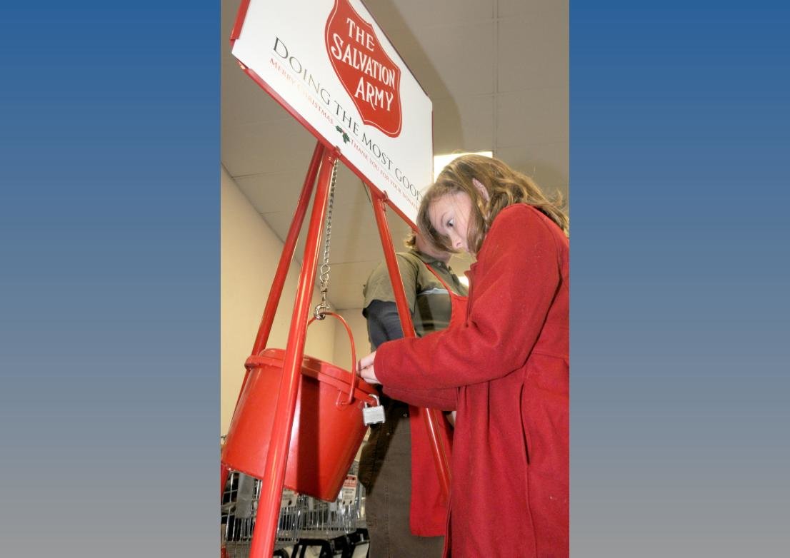 Casey Hunzkier, of Lee, makes a donation into a Salvation Army Red Kettle in the entry way at the Price Chopper/Market 32 store on Black River Boulevard. The donation, Salvation Army officials said, and others like it, fund much needed programs and services for thousands across the city.
