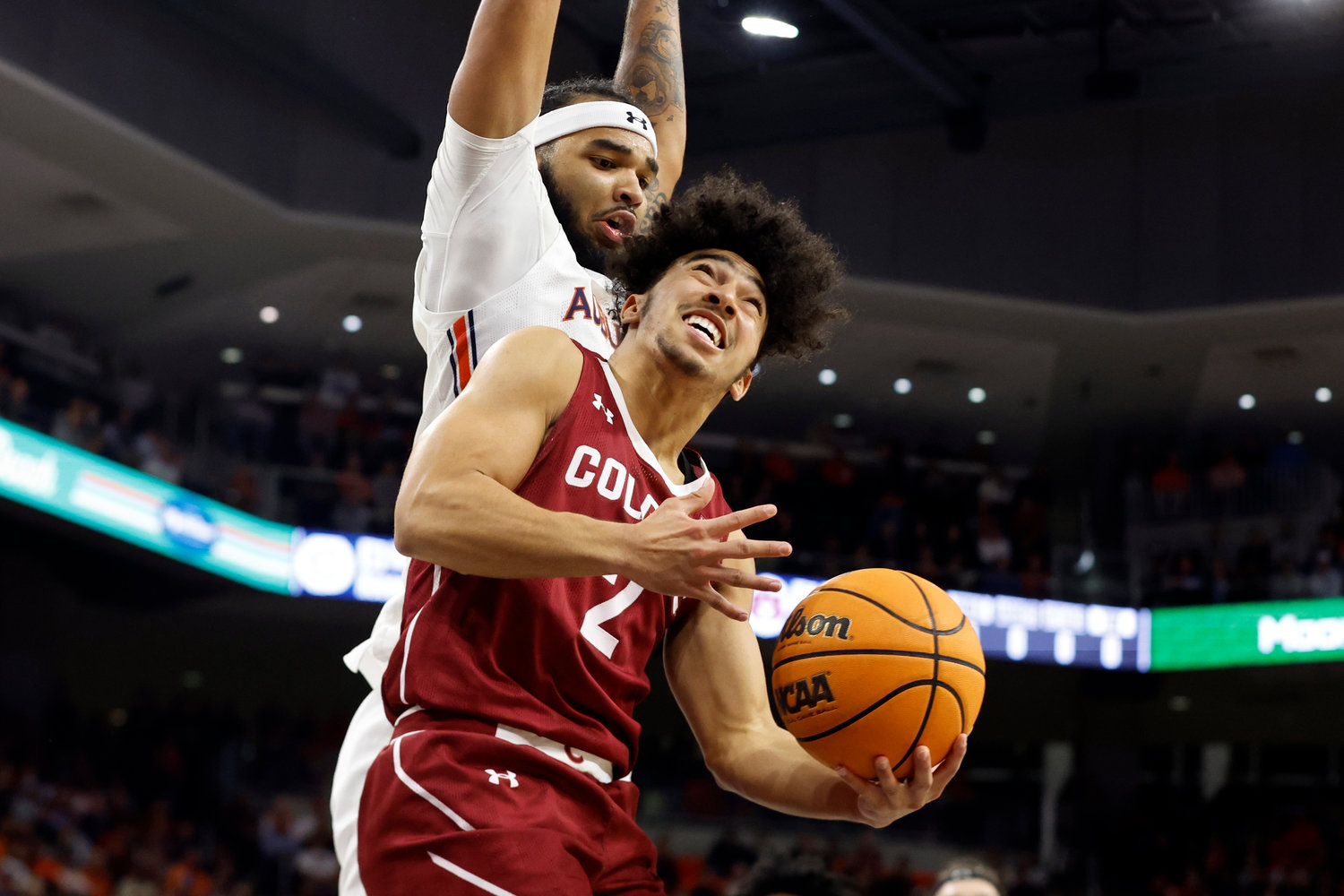 Colgate guard Braeden Smith (2) tries to shoot against Auburn forward Johni Broome during the first half of Friday night's game in Auburn, Ala. Auburn won 93-66.