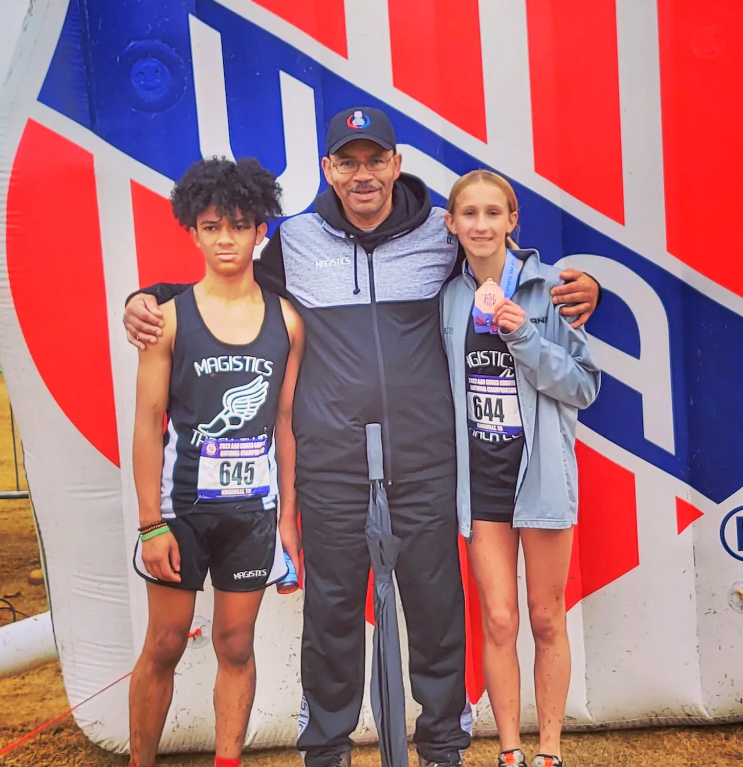 Two local runners competed in the AAU National Cross Country Championships Saturday in Knoxville, Tennessee. Eighth graders Emma Szarek, right, and Willie Bellamy, left, members of the Magistics Track Club, both competed in 4,000-meter races in the 13-14 age group. With them is coach Jim Peterson.