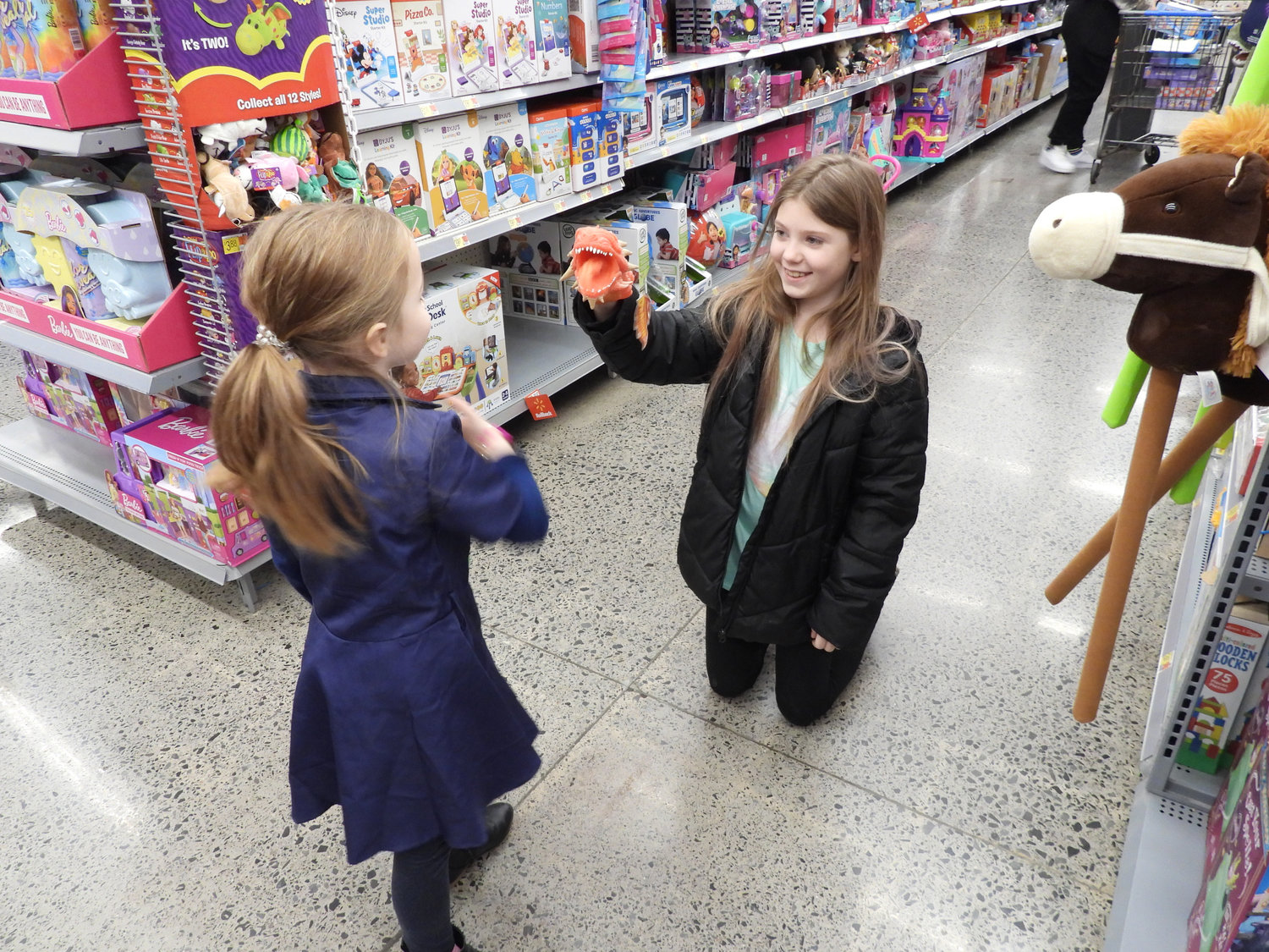 Ashlee Shanahan, 9, of Munnsville, plays with six-year-old Eliana Gates during the Madison County Shop with a Sheriff event on Saturday, Dec. 3