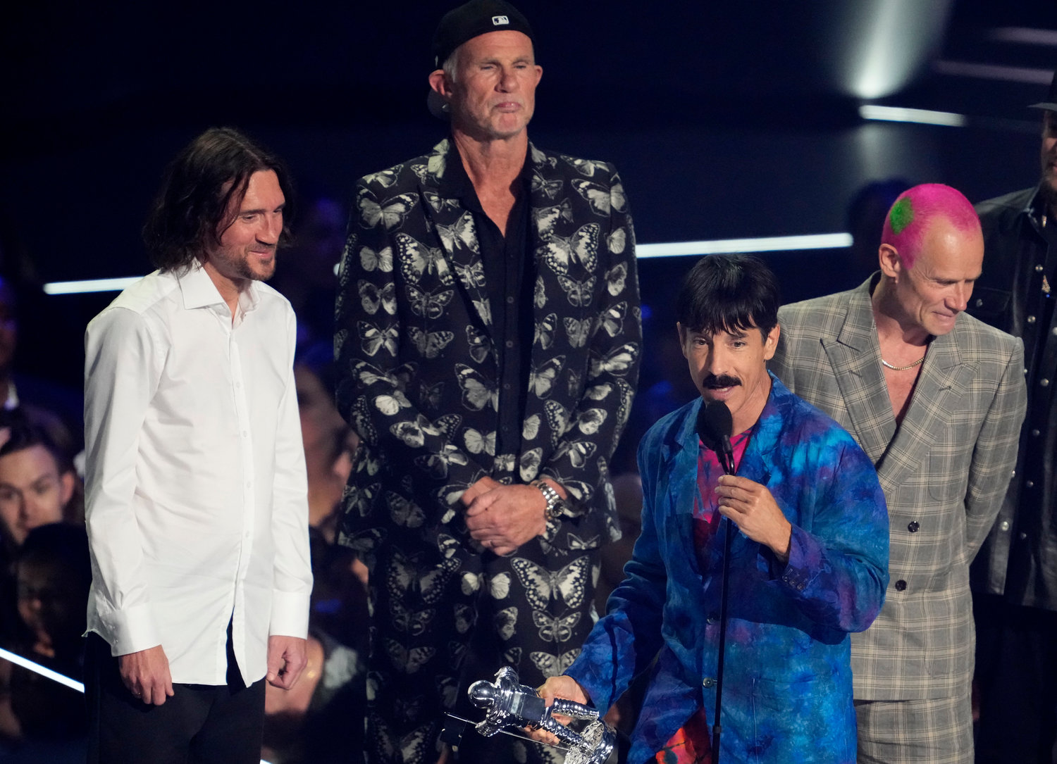 Anthony Kiedis, of Red Hot Chili Peppers, accepts the award for best rock for "Black Summer" at the MTV Video Music Awards at the Prudential Center on Sunday, Aug. 28, 2022, in Newark, N.J. From left looking on are fellow band member John Frusciante, Chad Smith and Flea. Fresh off a world tour and two albums this year, Red Hot Chili Peppers are preparing for a set of stadium shows and festival stops across North America and Europe in 2023.