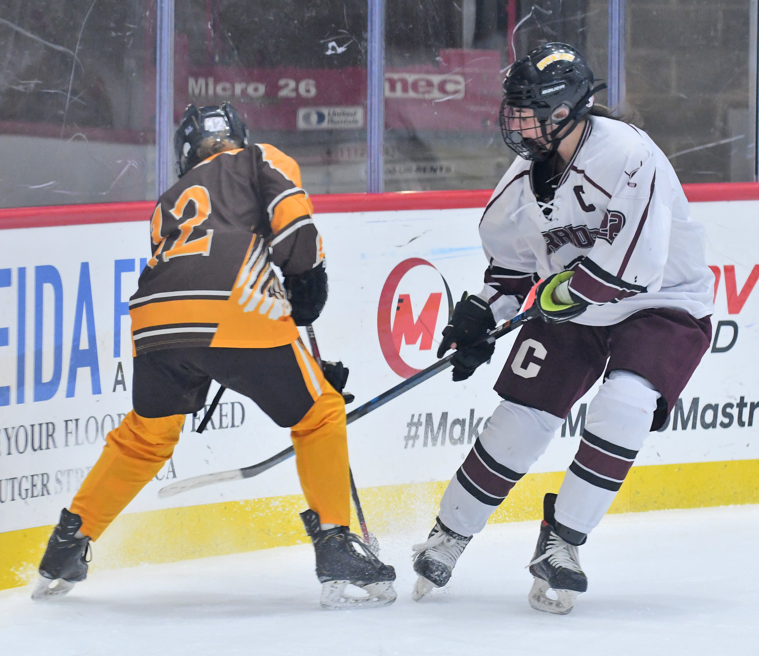Clinton co-captain Drew Kopek, right, battles Canton’s Chloe Baxter for the puck in the corner at the Nexus Center in Utica Monday ngiht. Kopek scored the eventual game-winning goal in the second period to break a 1-1 tie. Kopek also had an assist on the team’s other goal in a 2-1 win.