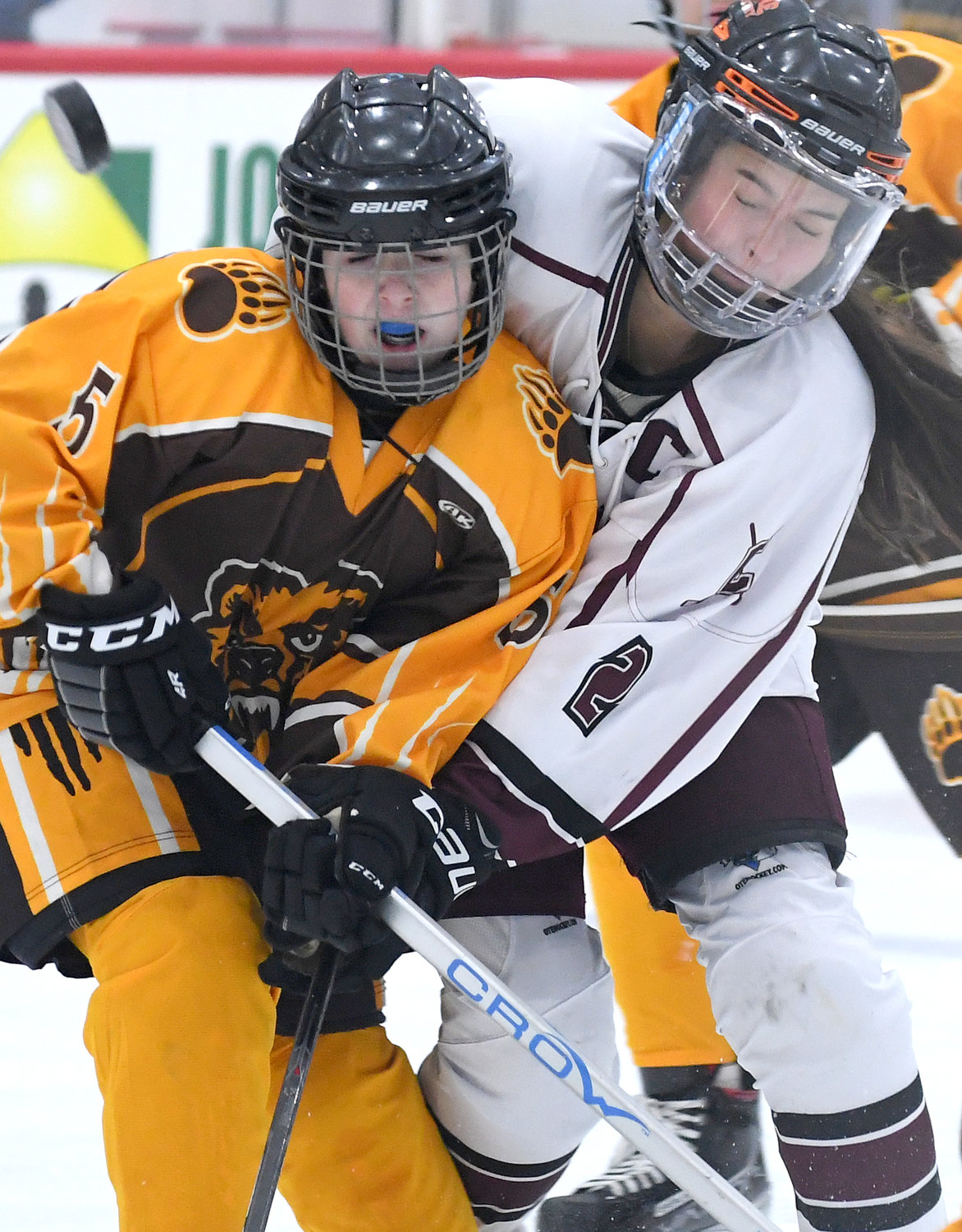 Clinton co-captain Sadie Davignon, right, collides with a Canton player in front of the Golden Bears' goalie in the first period Monday night at the Nexus Center in Utica. Clinton won 2-1.