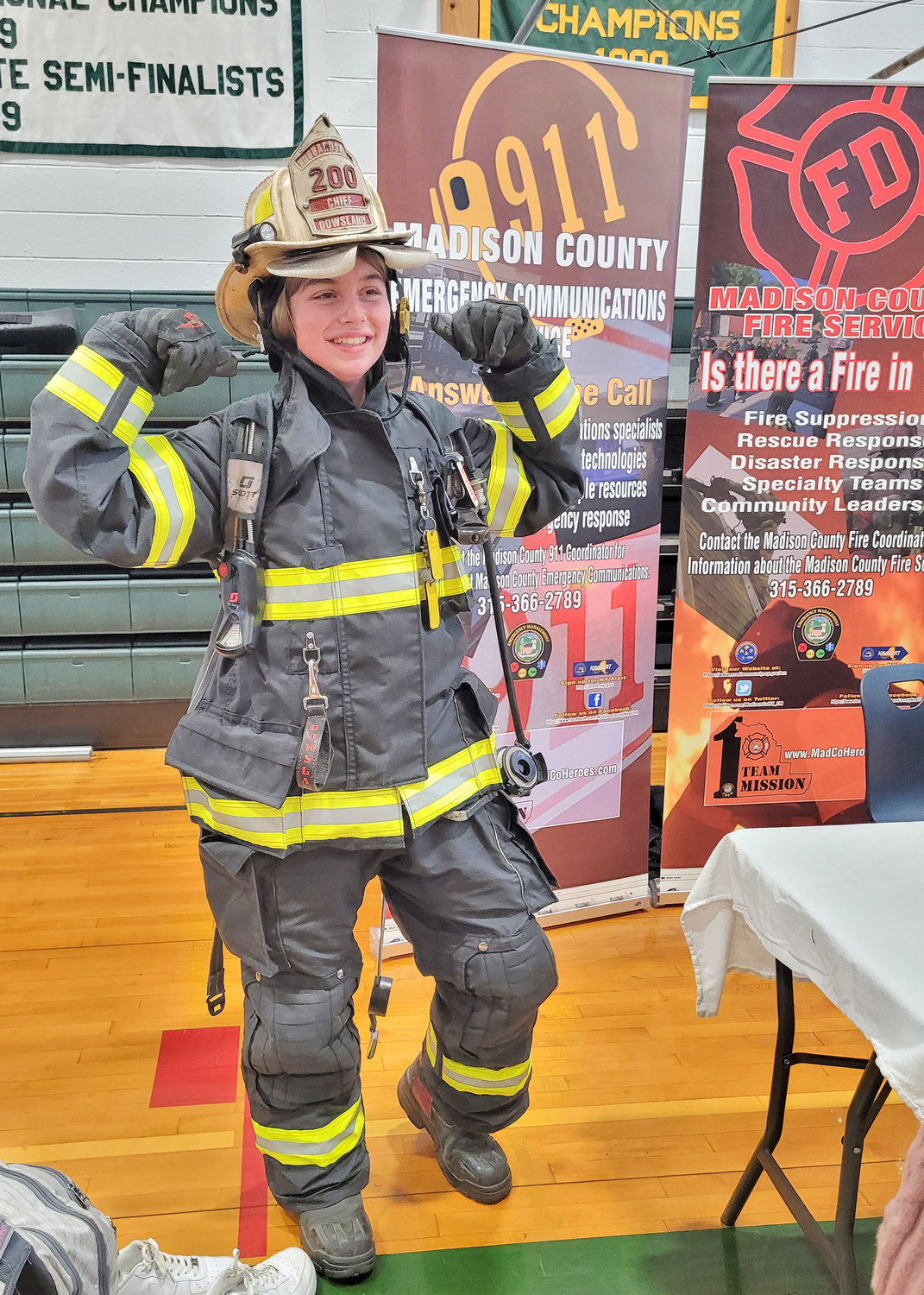 Hamilton Central School seventh grader Izzy Catania tries on a Hubbardsville Fire Department fire suit Nov. 18 during the school’s first-ever Career Fair.