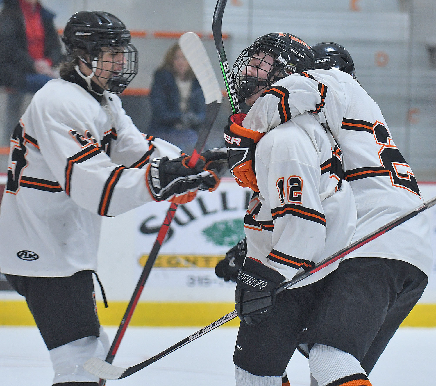 RFA celebrates a first period goal with Jake Premo mobbed by Jacob Swavely, right, and Carmen Orton (left) on Friday at Kennedy Arena.