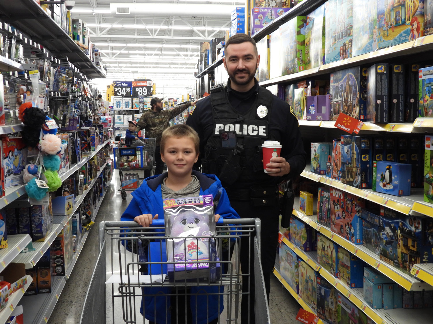 More than 80 children got a chance to shop with a cop at the Oneida Police Department's annual Shop with a Cop, where they got to meet and talk with local police officers while shopping for everything on their Christmas list. Pictured is eight-year-old Brayden Mason, shopping with Officer Tyler Witchley.