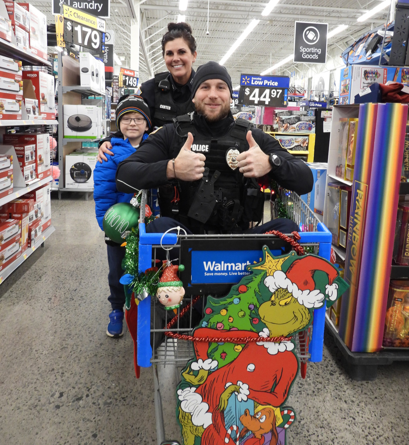 More than 80 children got a chance to shop with a cop at the Oneida Police Department's annual Shop with a Cop, where they got to meet and talk with local police officers while shopping for everything on their Christmas list. Pictured is seven-year-old Urijah Cox, shopping with Officer Sarah Carter, with Officer Denny Kowalski riding in their festive shopping cart.