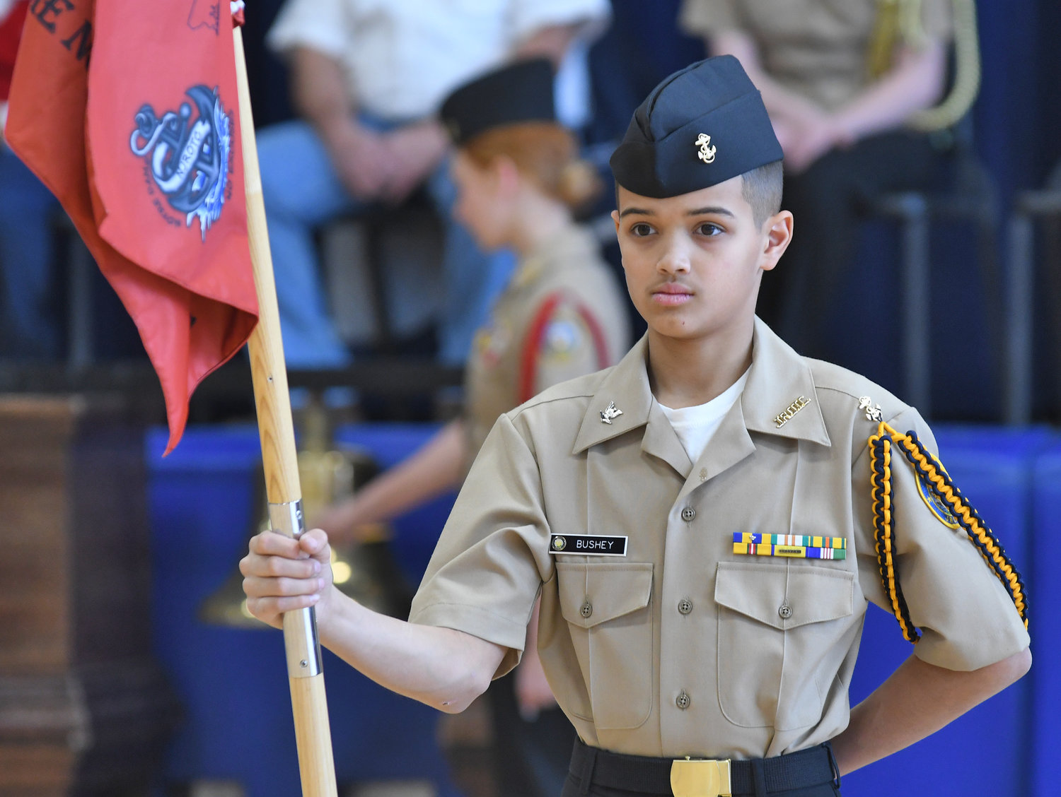 Notre Dame Navy Junior ROTC member Jamarhy Bushy stands at attention with the unit's guidon Monday, Dec.12 during the Wreaths Across America ceremony at the Utica high school.