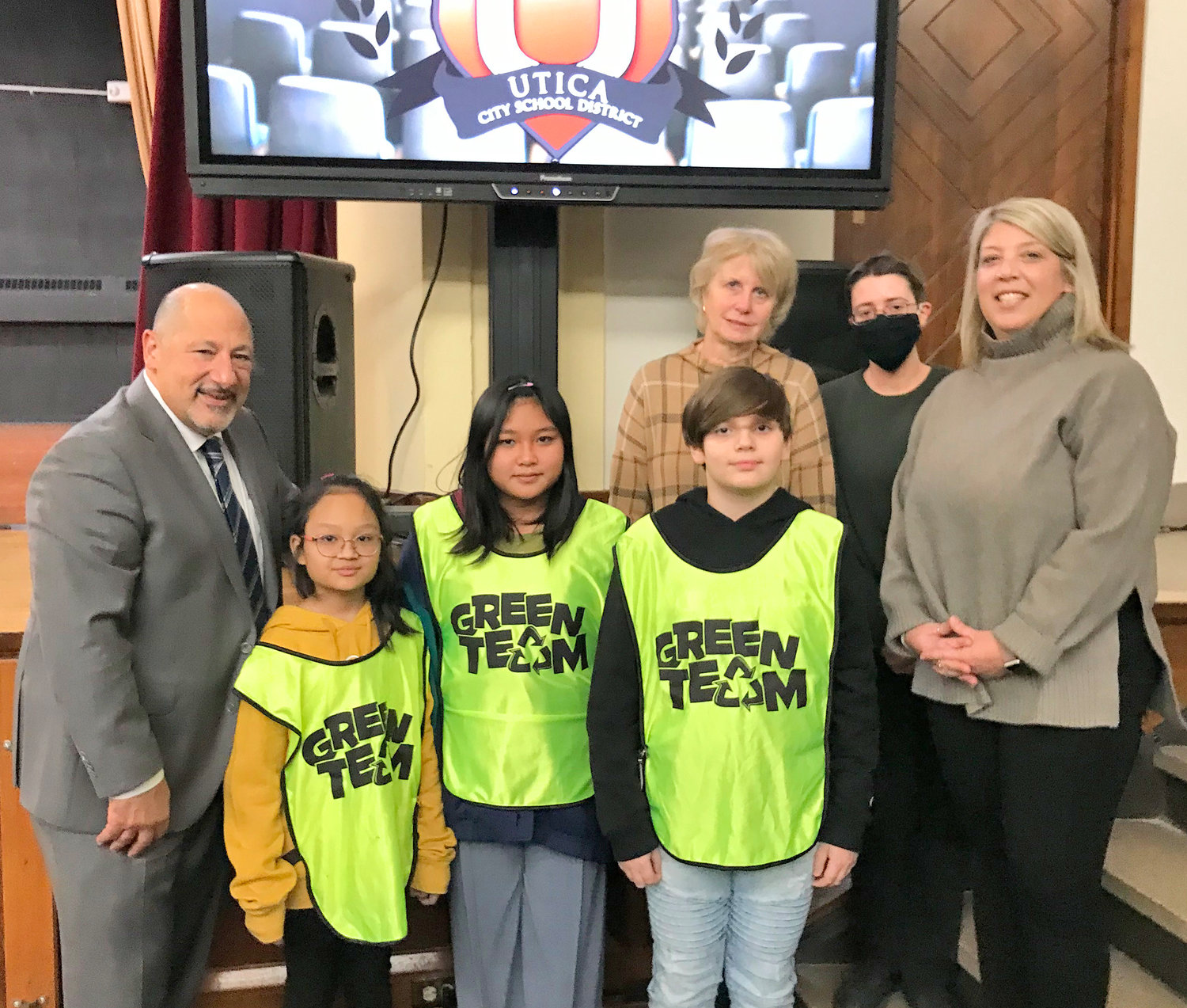 Members of the Conkling Elementary School Green team and their advisors pose Dec. 13 with Utica City Schools Board of Education President Joseph Hobika Jr., left, during the board's meeting at the Kernan Elementary School in Utica.