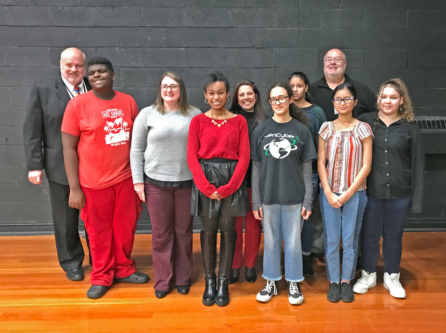 Members of the Proctor High School Newspaper Club pose Dec. 13 with district Superintendent Brian Nolan, left, during the board's meeting at the Kernan Elementary School in Utica.